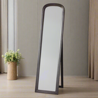 Brushed brass cheval mirror in a bedroom