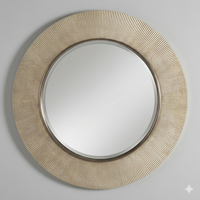 Brushed bronze circular mirror with fluted textured frame on a neutral background.