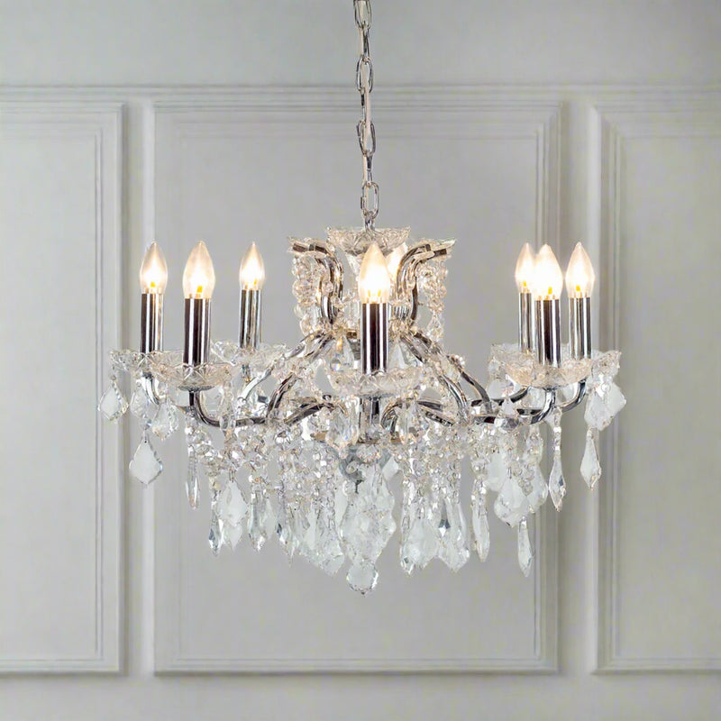 Chrome shallow 8-arm crystal chandelier with faceted crystal droplets.