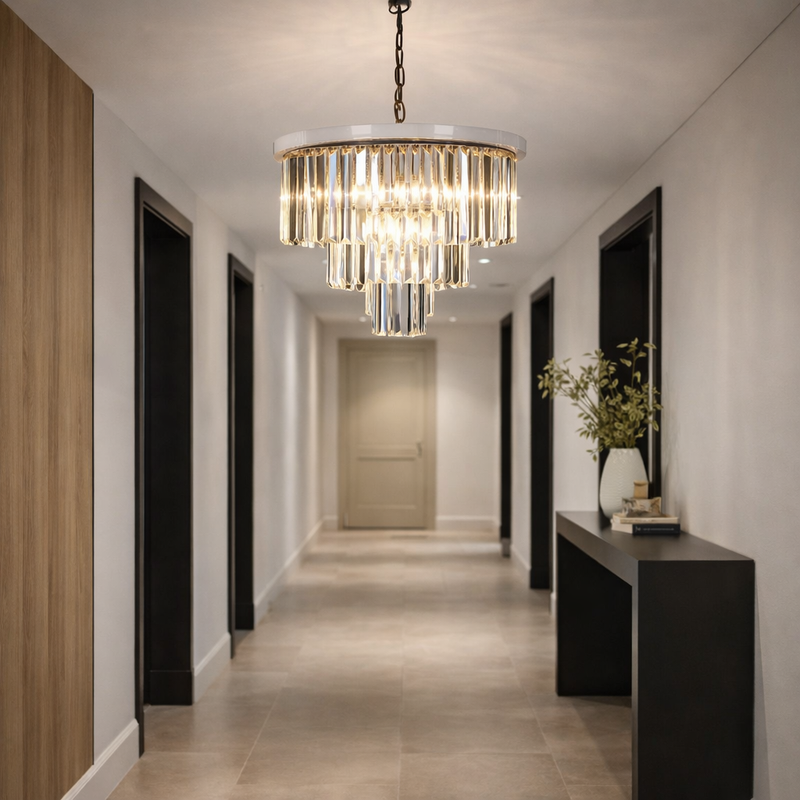 Modern hallway with a chandelier, console table, and decorative elements.