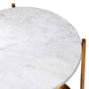 Close-up of a white marble top on a two-tier side table with a gilt metal frame, showcasing luxurious design and smooth finish.