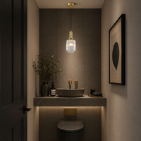 Clear glass, long ribbed pendant in a grey modern cloakroom. 