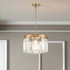 Compact 40 cm chandelier with a brushed gold band and hanging prism-cut crystals, suspended from an adjustable gold chain.