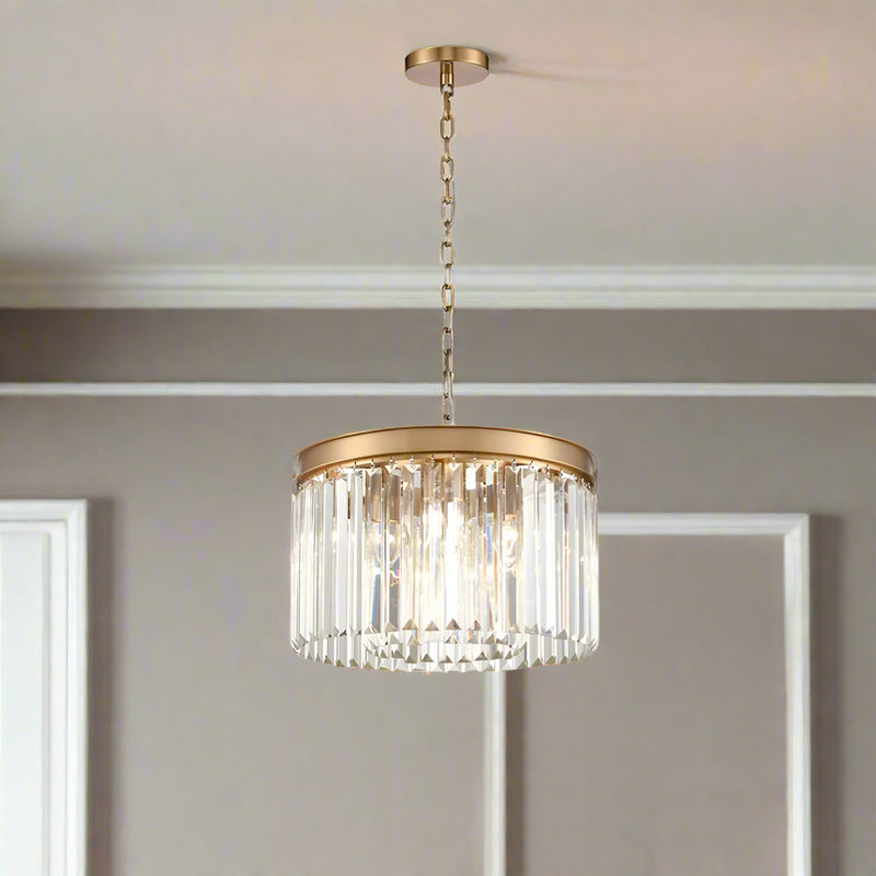 Compact 40 cm chandelier with a brushed gold band and hanging prism-cut crystals, suspended from an adjustable gold chain.