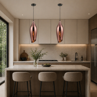 Copper lights over the island in a ultra modern kitchen situ.