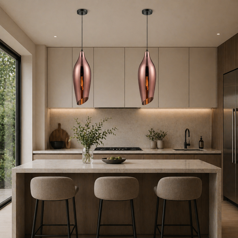 Copper lights over the island in a ultra modern kitchen situ.