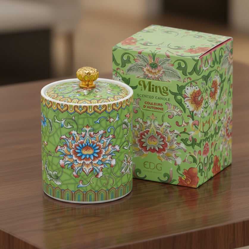 Handcrafted green ceramic scented candle jar with gold detailing and floral pattern, scented with warm amber, florals, and woods.