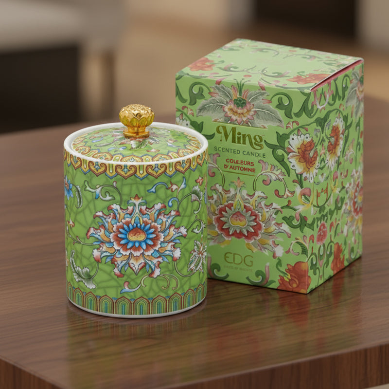 Handcrafted green ceramic scented candle jar with gold detailing and floral pattern, scented with warm amber, florals, and woods.