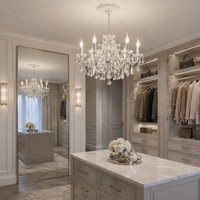 Six branch white crystal chandelier in a luxury dressing room reflected in a floor standing mirror.