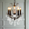 French bronze five-arm crystal chandelier with ornate frame and crystal droplets.