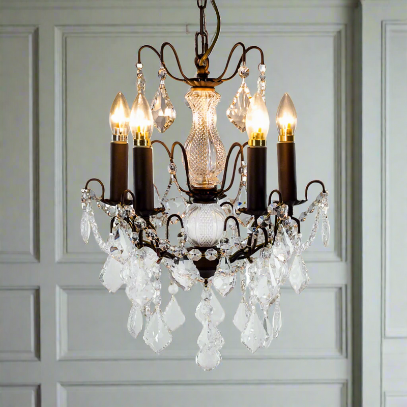 French bronze five-arm crystal chandelier with ornate frame and crystal droplets.