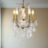 French gold five-arm crystal chandelier with faceted crystal droplets in living room