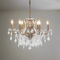 A beautiful six-arm crystal chandelier set on a warm gilt metal frame. With its shallow proportions and cascading crystal drops.