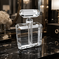 Stunning, oversize crystal perfume bottle on a black marble table top in a luxury dressing room.