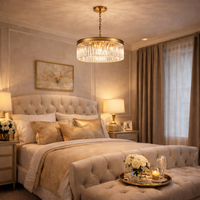 Luxurious bedroom with a gilt chandelier and luxury linens.