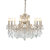 This grand twelve-arm chandelier blends a silver frame with layers of sparkling crystals, creating a soft, romantic glow that brings elegance to any room.