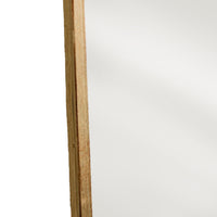 Close-up of the gold metal frame on the curved mirror