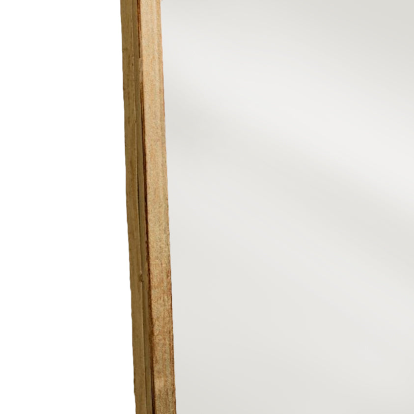 Close-up of the gold metal frame on the curved mirror