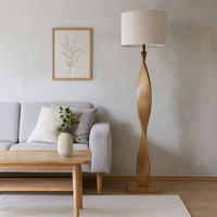 Pale wooden curved floor lamp, great in a Scandi interior. The design is exceptional in a living room or hall the pale linen shade allows light to our out.