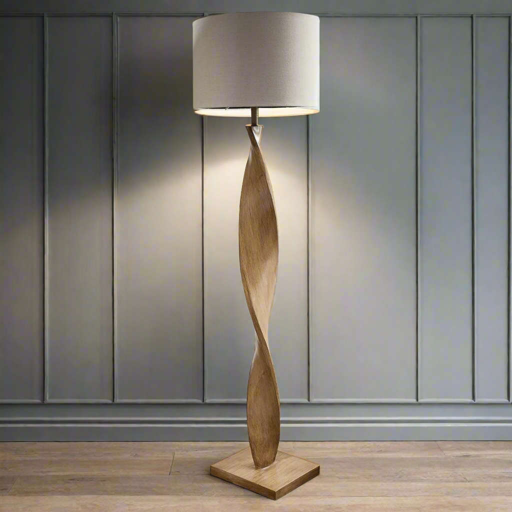 Pale wooden curved floor lamp, great in a Scandi interior. The design is exceptional in a living room or hall the pale linen shade allows light to our out.