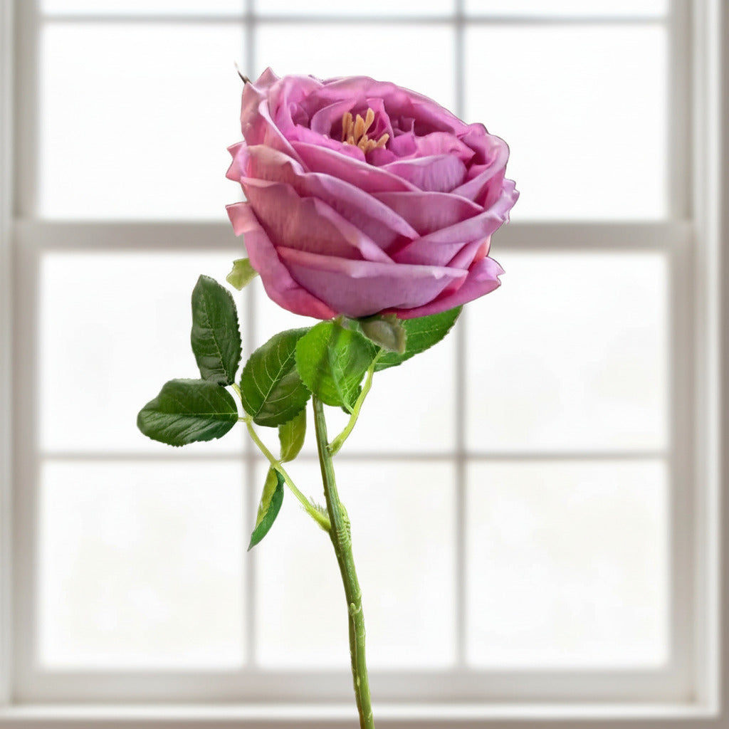 This ultra-realistic artificial dark pink rose features rich, velvet-like petals and a vibrant green stem with textured leaves.