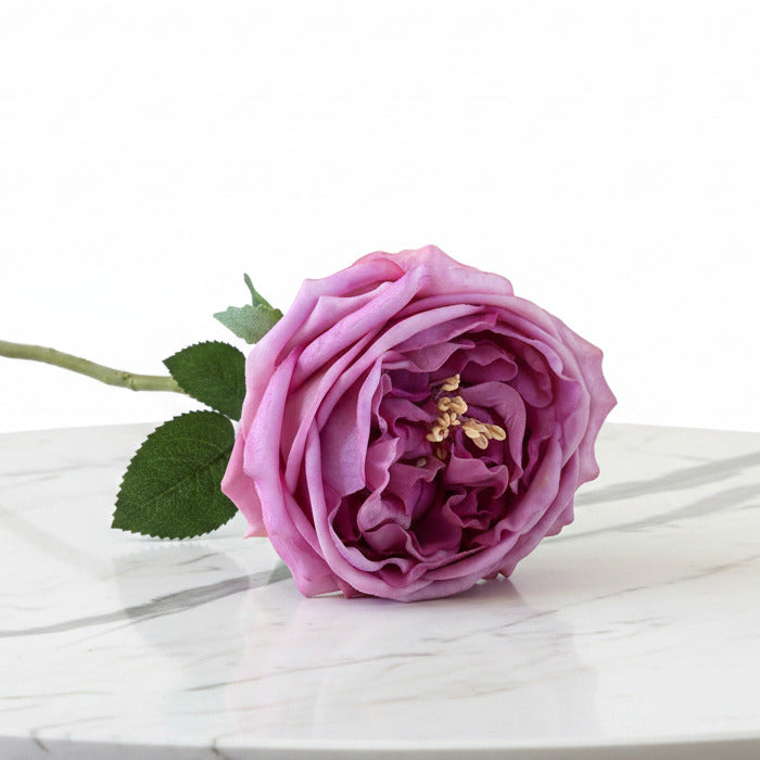 This ultra-realistic artificial dark pink rose features rich, velvet-like petals and a vibrant green stem with textured leaves.