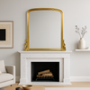 Antique giltwood overmantle mirror with arched top and ornate scrollwork base, finished in aged gold leaf, styled for traditional fireplace décor.