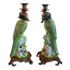 Pair of bronze and coloured porcelain parrot candle holders on ornate bases.