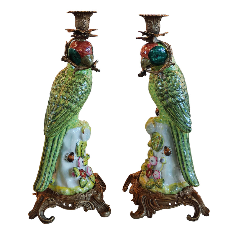Pair of bronze and coloured porcelain parrot candle holders on ornate bases.