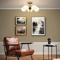 Modern living room with brown leather chair, side table, and wall art.