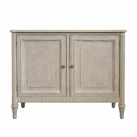 Vintage-style two-door sideboard with light wood finish, paneled doors, and turned legs