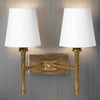 Double rubbed antique brass ribbed wall light with two fabric shades.&nbsp; The sturdy wall light is perfect for a living room or a bedroom.&nbsp;&nbsp; You get the added bonus of twice the amount of light, in a dark hallway or landing. The addition of two fabric shades allows the light to stream out.&nbsp;