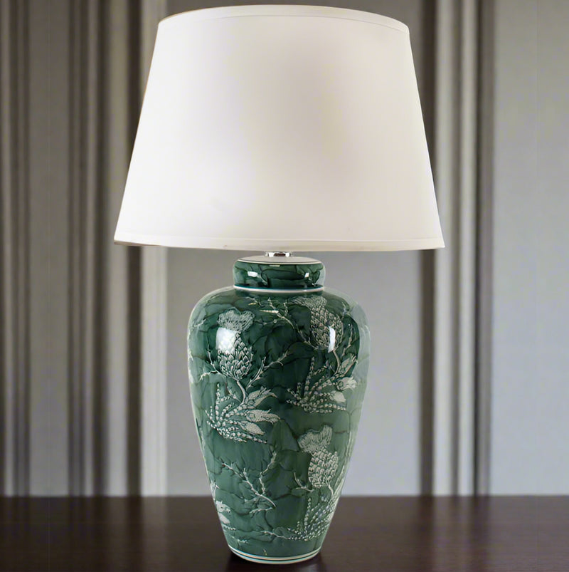 &nbsp;An unusual take on the classic blue and white, this stunning thistle patterned green and white lamp is so perfect with a large white shade. A particularly stunning colour a really vibrant green showing the thistle pattern,&nbsp; When illuminated through the pale coloured linen shade the light from the lamp will enhace the light in any room. Perfect on a console table behind a sofa or a hll. Check our website for a range of large ceramic lamps and shades.


H: 70 cm W: 43 cm