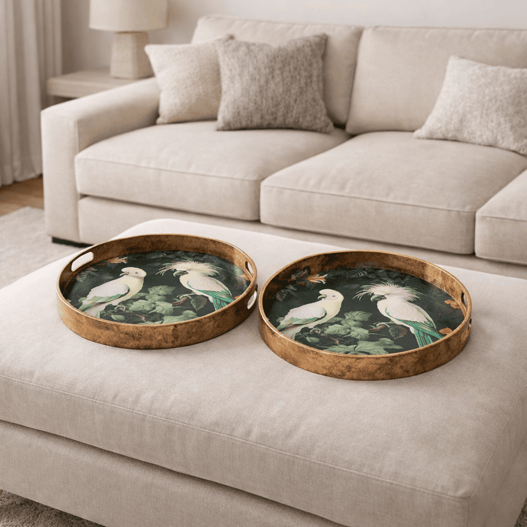 Two decorative trays with bird designs on a beige ottoman in a living room 