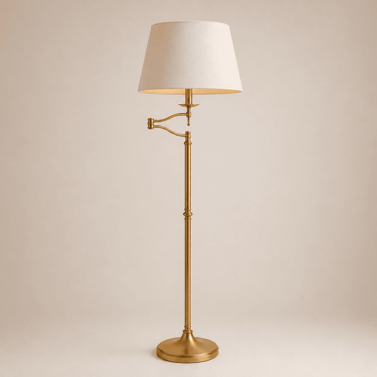 Brass extending arm floor lamp with adjustable swing arm and cream fabric shade on neutral background