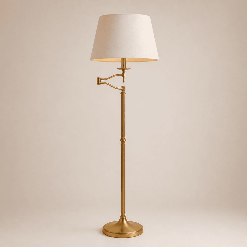 Brass extending arm floor lamp with adjustable swing arm and beige lampshade