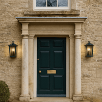 Two exterior lantern lights either side of a country house door with coloumns.