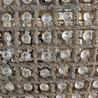  large, aged brass crystal globe chandelier with crystal beading encased in brass metalwork that reflects a pretty pattern around your ceiling and walls. 