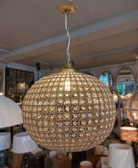 Extra, extra large, aged brass crystal globe chandelier with crystal beading encased in brass metalwork that reflects a pretty pattern around your ceiling and walls. 