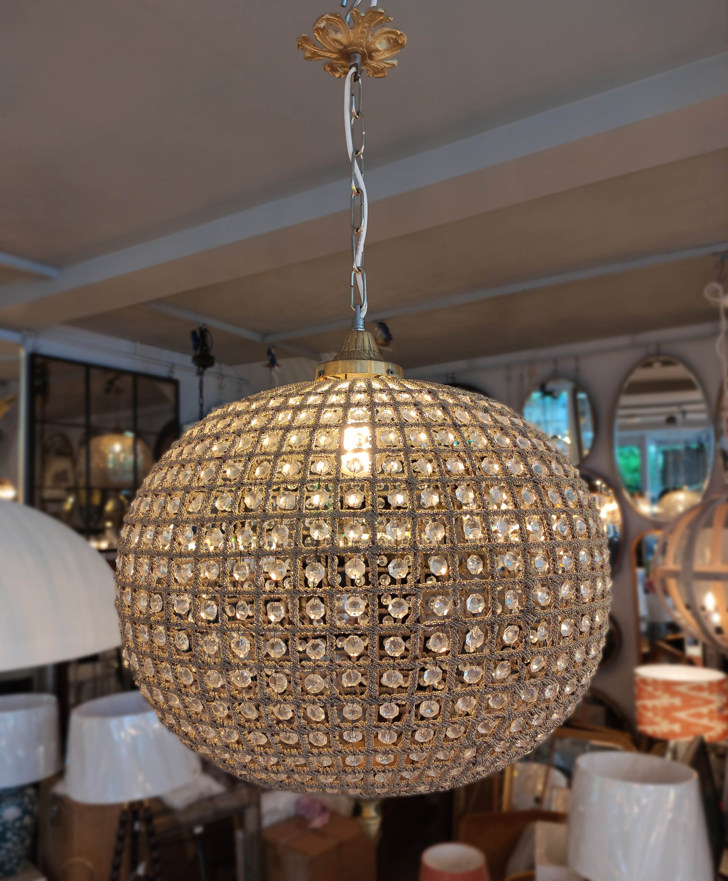 Extra, extra large, aged brass crystal globe chandelier with crystal beading encased in brass metalwork that reflects a pretty pattern around your ceiling and walls. 