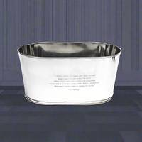 An extra large silver steel ice bucket with engraved 'Lily Bollinger' quotations on it, displayed against a paneled background.