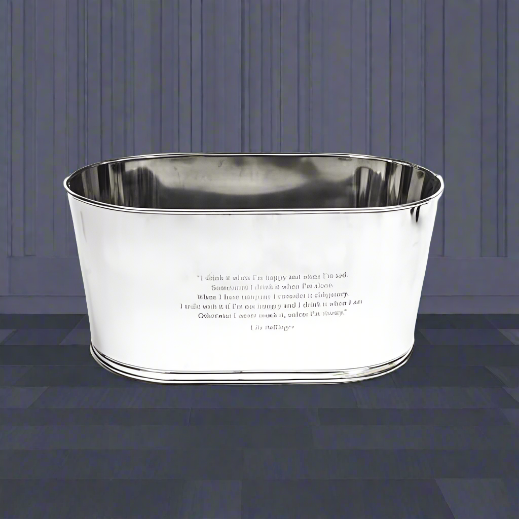 An extra large silver steel ice bucket with engraved 'Lily Bollinger' quotations on it, displayed against a paneled background.