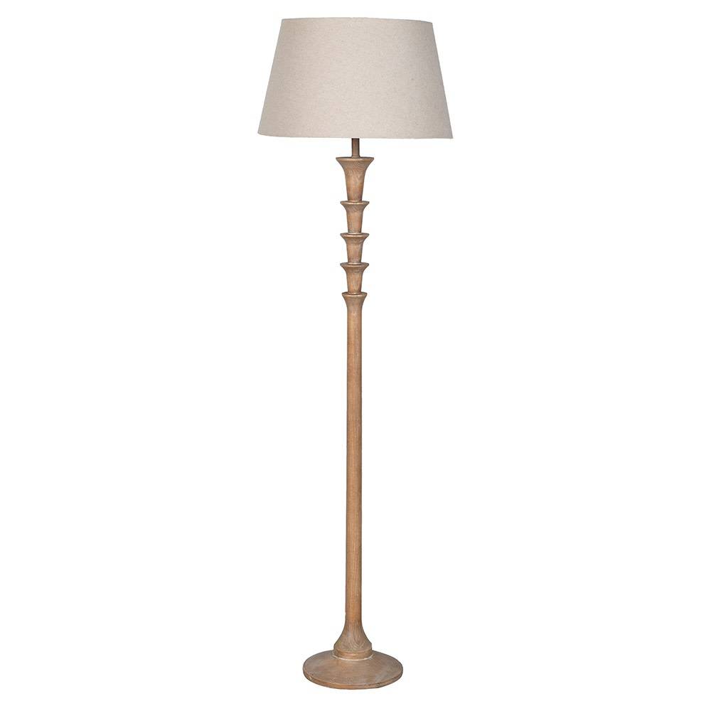 A floor lamp with a tall, slender distressed wood base and a tapered beige fabric drum shade, shown against a plain white background.