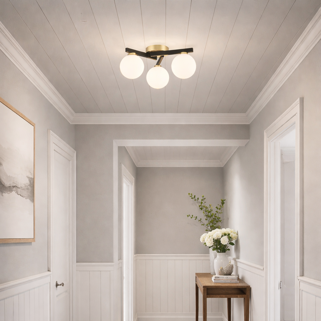Flush three globe light, on a ceiling in a modern hall, with console table