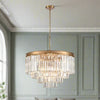 Four‑tier chandelier with cascading clear crystal rods and a polished gold band, hanging from an adjustable chain.