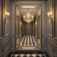 Luxurious interior with a large ornate mirror reflecting a chandelier and walls.