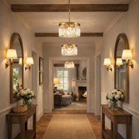 Elegant hallway with chandeliers, mirrors, and floral arrangements.