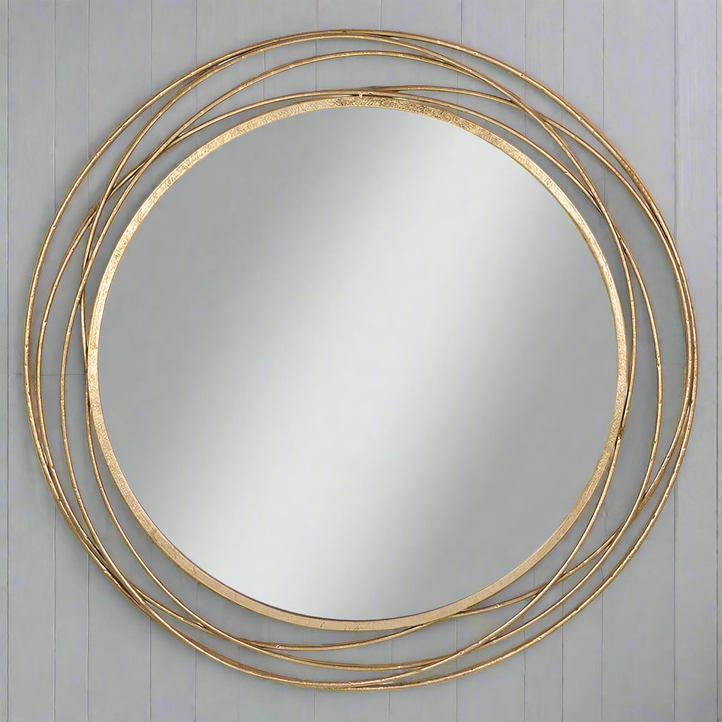 Circular mirror in gilt finish on a paneled grey wall.