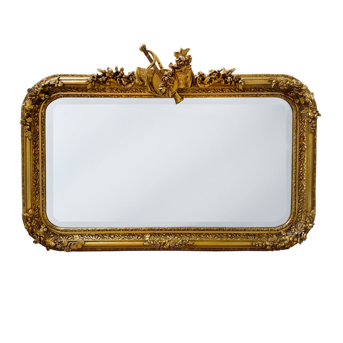Luxurious ornate gold overmantle mirror with carved floral crest and gilt frame. Perfect statement mirror for fireplaces, hallways and elegant period interiors. Plain image of product.