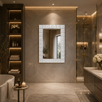 Luxurious glass framed mirror in luxurious bathroom setting.